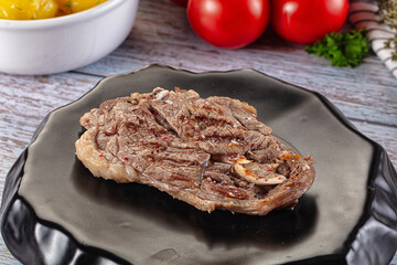Grilled lamb steak with bone
