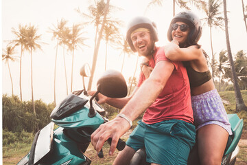 Romantic caucasian couple riders sit on rented scooter watch sunset in sri lanka . Freedom and...