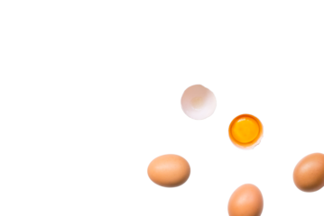 Closeup of brown organic free-range chicken eggs with broken egg isolated on a transparent background from above, top view, png