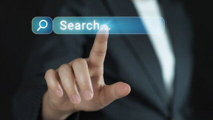Businessman hand touching a virtual search bar on transparent screen, global internet connection, data access, and online information.technology for future business