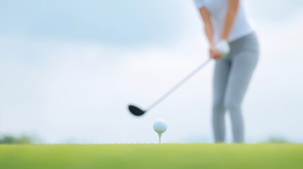 Golf player prepares to strike the ball on the green during a cloudy day in a serene outdoor golf course.