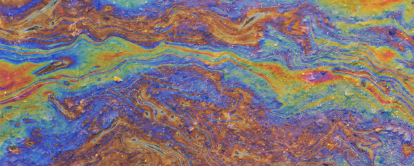 puddle gasoline background, wet oil multicolored rainbow pollution spill