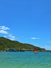 Red sailing boat, trimaran multicolored sail floating on the sea, catamaran in the sea, Sailing in...