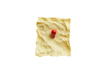 Crumpled yellow paper note with a red push pin isolated on black background