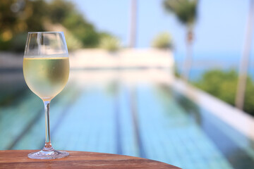 glass of cold white wine on the summer seashore by the water, relaxing by the water, a gentle background of soft color
