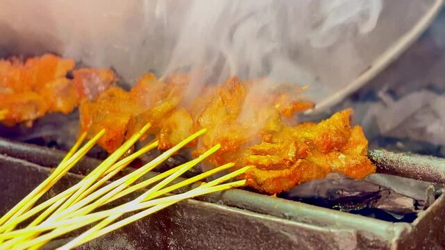 Sate Padang or Padangnese skewers being grilled at a street vendor.