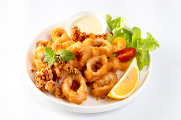 Fried Calamari: Tender calamari rings coated in seasoned batter, deep-fried to crispy perfection, served with marinara or aioli for dipping.