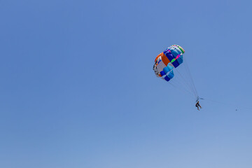 Tekirova, Turkey - June 7, 2025: Tourists are extremely entertained flying parasailing