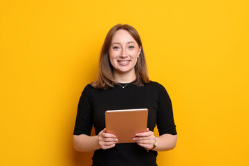 Fototapeta premium Woman with modern tablet on orange background