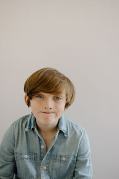 Young boy in chambray shirt with neutral expression