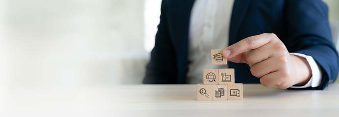 Online Education and E-Learning Concept. Wooded blocks with educational tool icons, remote and online learning, digital training, webinars on the internet for personal development.