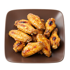 A plate of golden-brown chicken wings garnished with sesame seeds, served hot