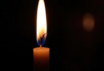 Candle flame illuminating darkness: study in light shadow