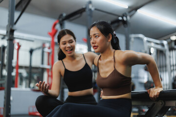 Fototapeta premium Young women training together in gym, fitness and friendship goals