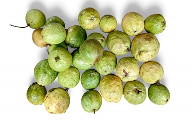 A cluster of guava fruits against a white background. The guavas vary in color from green to yellow.