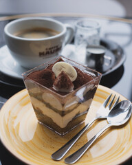 Tiramisu dessert with coffee on a cozy café table