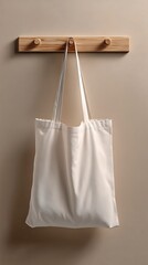 Hanging white tote bag on a wood rack against a light brown textured wall