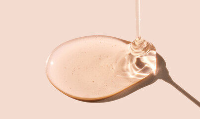 drop gel serum on beige background