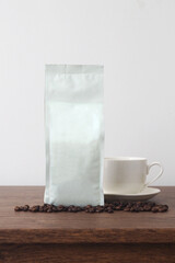 White blank coffee bag on wooden table. Packaging mockup with empty space for you designs.