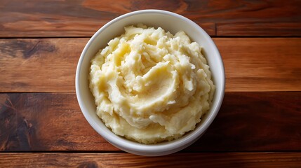 Bowl of Creamy Mashed Potatoes on Wooden Table