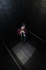 Woman  in a black room with high angle