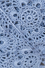 Close up of hands of unrecognizable woman knitting handmade clothes with spokes using  wool yarn. Concept of leisure activity.Knitting from yarn on  coarse spokes.