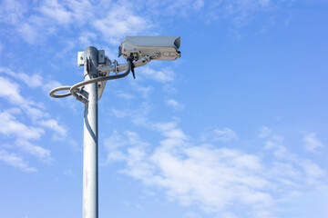 CCTV outdoor camera, building security guard. area safety surveillance cam with blue sky background