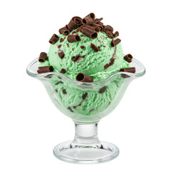 Mint chocolate chip ice cream in a glass bowl, topped with chocolate curls, on a white background