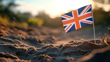 Small British flag planted in a sandy surface, evoking themes of nationalism and identity against a blurred background.