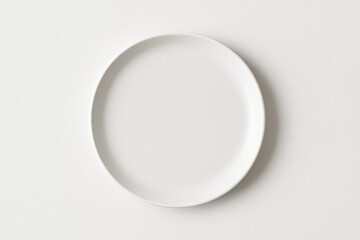 White plate with colorful fruits on a white surface.