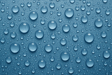 water drops on blue background, reflecting light in a mesmerizing pattern, showcasing nature's simplest beauty.