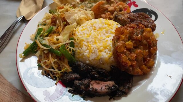 4k video footage of Sego Jagung is a javanese traditional dish contains of white rice mixed with chopped corn kernels and various side dishes.