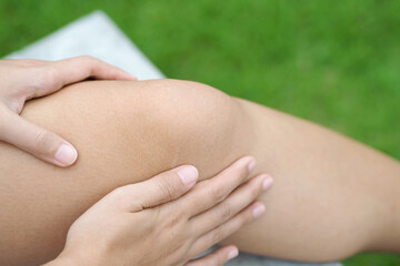 Knee Pain. Young woman suffering from knee pain.