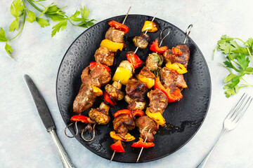 Grilled pork shish kabab skewers.