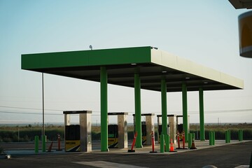 Gas station view with fuel pumps © Wirestock