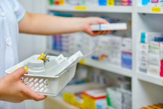 Pharmacist filling prescription in pharmacy drugstore
