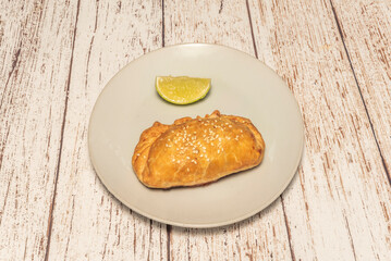 "empanada" as we know it today, with its distinctive crescent or round shape and scalloped edge, has its most direct origins in the Mediterranean region