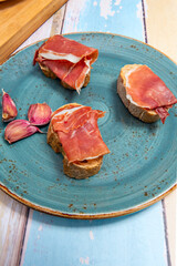 Freshly baked, crusty bread, a touch of olive oil, and slices of ham 