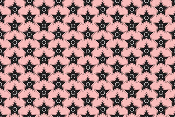 Black stars with white circles pattern on a pink background in a seamless design