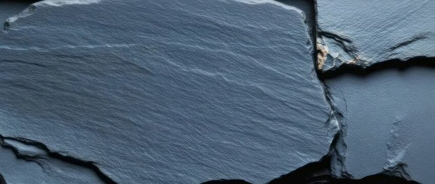 Creating textured surface art using natural slate stones in a workshop