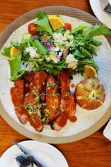 close up of fresh salads with beef steak and sauce on the plate