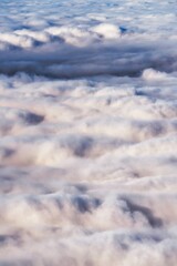 winter mountain landscape with snow, fog and cloud covered areas