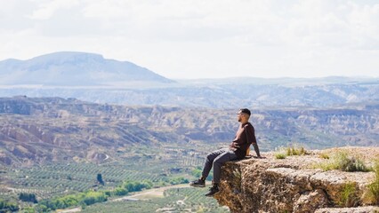 Tourist enjoying the scenic view from a cliff in gorafe, spain