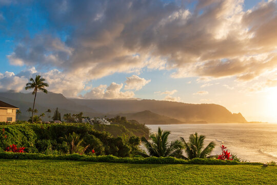 Scenic view of North Shore of Hawaiian island of Kauai with its famous Napali coast at sunset against blue sky with clouds