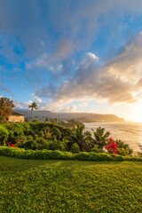 Scenic view of North Shore of Hawaiian island of Kauai with its famous Napali coast at sunset against blue sky with clouds