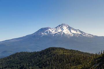 Fototapeta premium Layers of mountains, one green and one snowy