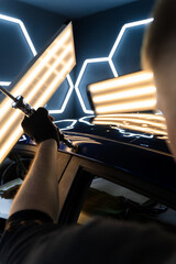 Using pulling tool for PDR on a glossy car roof, adjusting pressure precisely. Expert uses advanced...