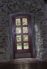 wooden, vintage door in the castle; reflection in the glass