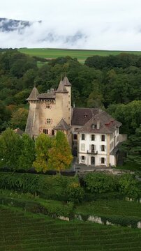 Vertical, aerial: parallax drone shot of Vaumarcus Castle during the day in canton of Neuchatel, Switzerland