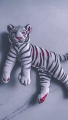 Plush white tiger on marble